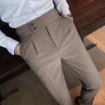 Taupe dress pants with pleats and a high waist paired with white shirt